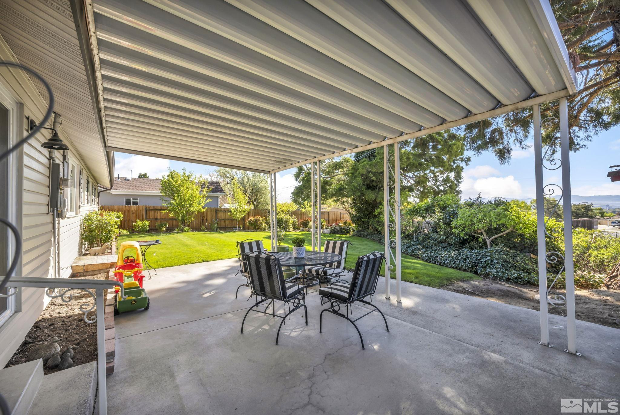 770 Rhode Island Drive Reno, NV 89503 - Photo 3 of 19 a view of a patio with a table chairs and a backyard