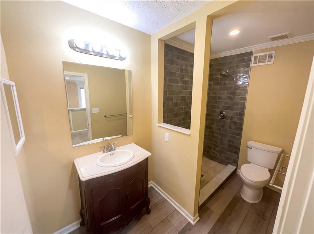 27 Chaumont Square Northwest Atlanta, GA 30327 - Photo 16 of 21 a bathroom with a sink a toilet and shower