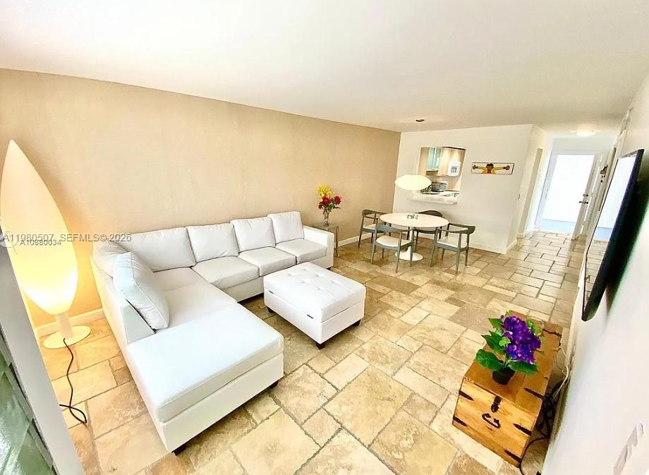 240 Galen Drive, Unit 314 Key Biscayne, FL 33149 - Photo 1 of 10 a living room with furniture and a floor to ceiling window