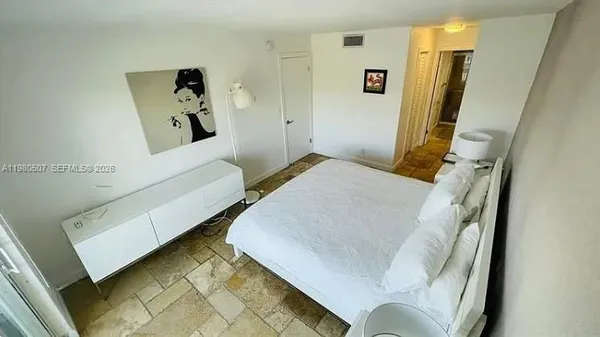 a bedroom with a bed and a couch