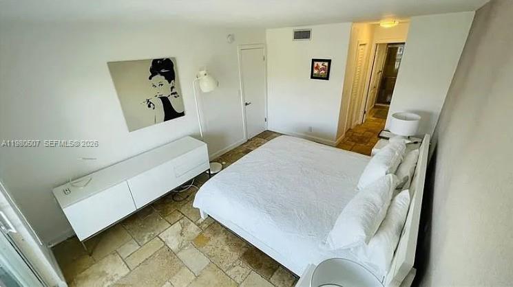 240 Galen Drive, Unit 314 Key Biscayne, FL 33149 - Photo 3 of 10 a bedroom with a bed and a couch