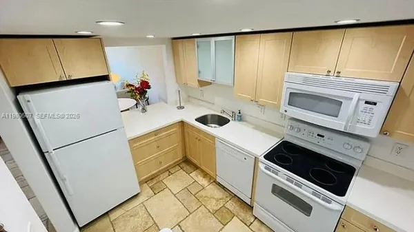 a kitchen with a sink cabinets and appliances