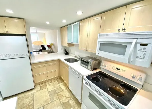 a kitchen with a sink stove and refrigerator