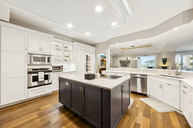 a kitchen with a sink cabinets and wooden floor