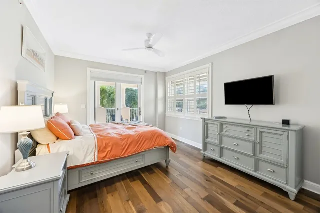 a view of a bedroom with wooden floor and stairs