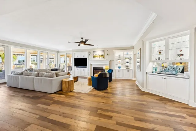a living room with furniture a fireplace and a wooden floor