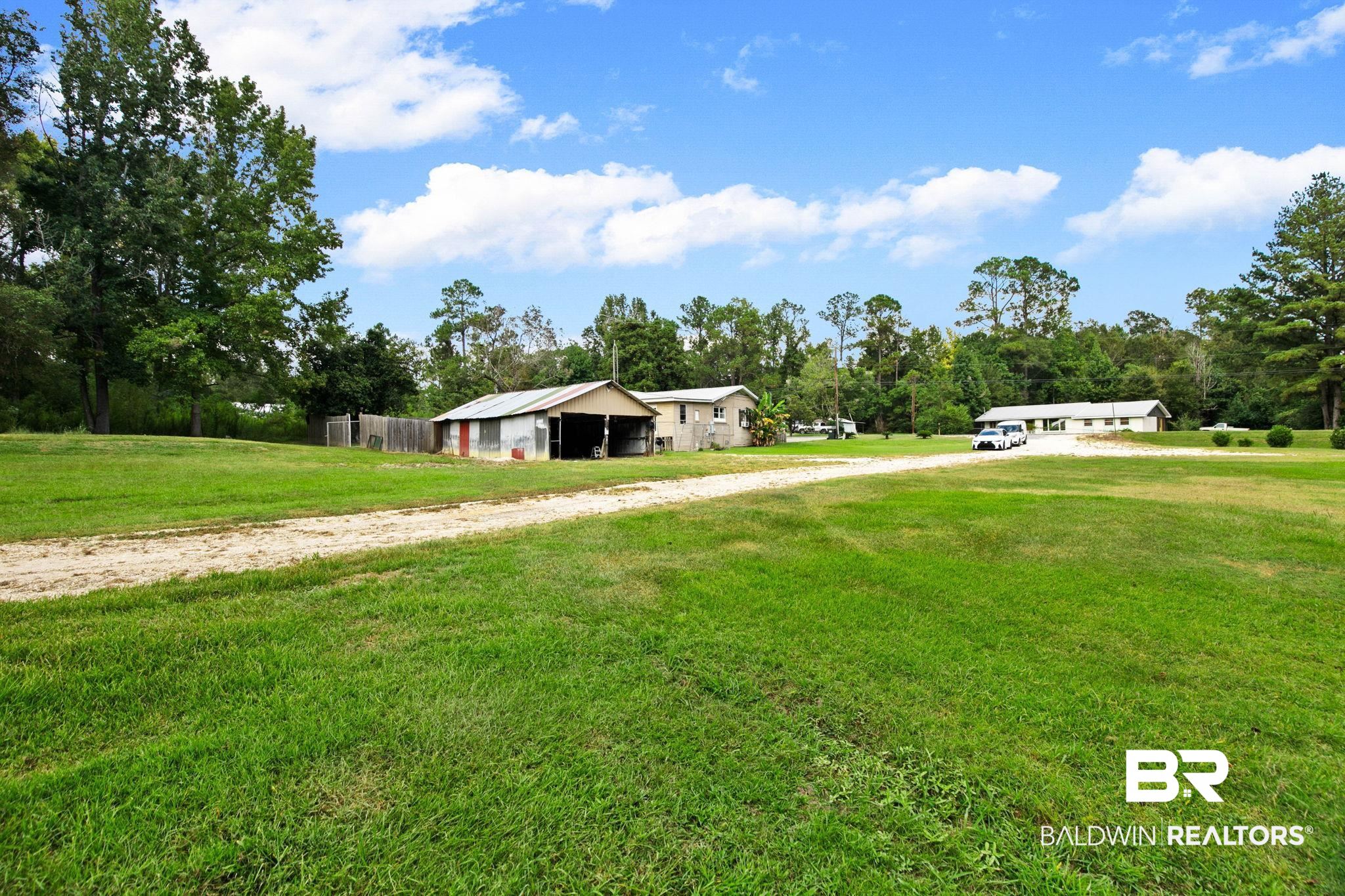 23240 County Road 47 Perdido, AL 36562 - Photo 29 of 29 View of grassy yard with an outbuilding, an outdoor structure, and driveway