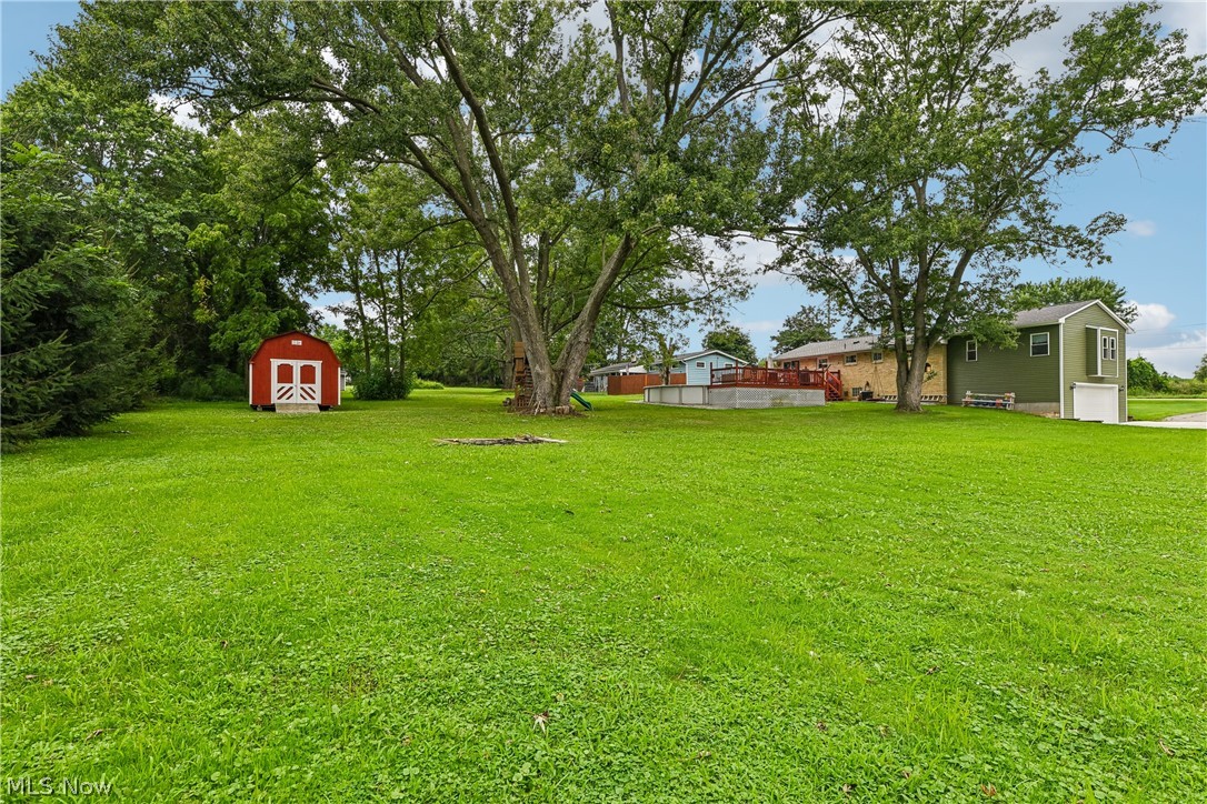 15111 Mt Eaton Road North Rittman, OH 44270 - Photo 38 of 50 Expansive back yard with mature trees, a red storage shed