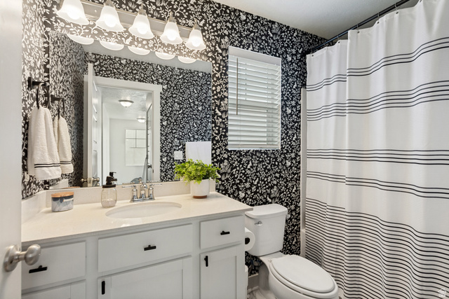 7693 West Mount Elinor Road Magna, UT 84044 - Photo 22 of 33 White vanity with an integrated sink and matte black hardware