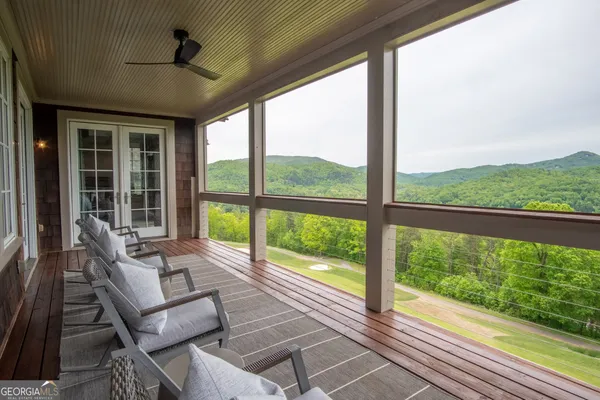 a view of a balcony with wooden floor