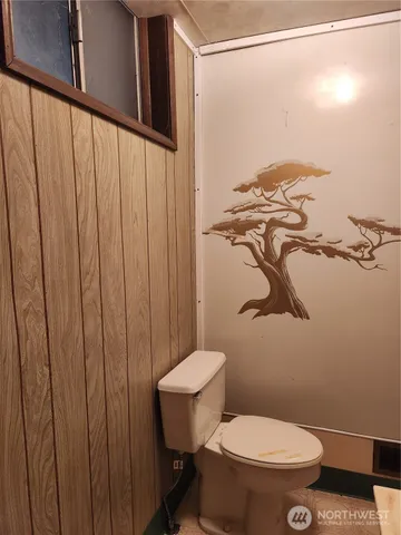 a bathroom with a toilet and a shower