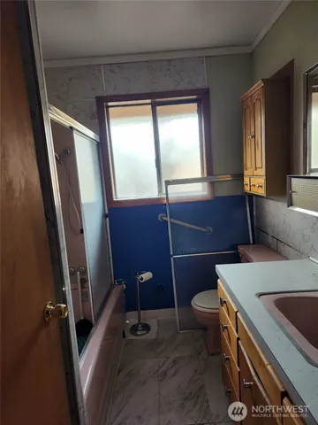 a bathroom with a sink a toilet and a mirror