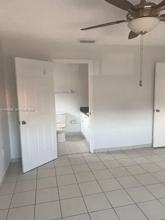 a view of a room with white walls and tiles