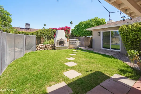 a view of a house with a yard and sitting area