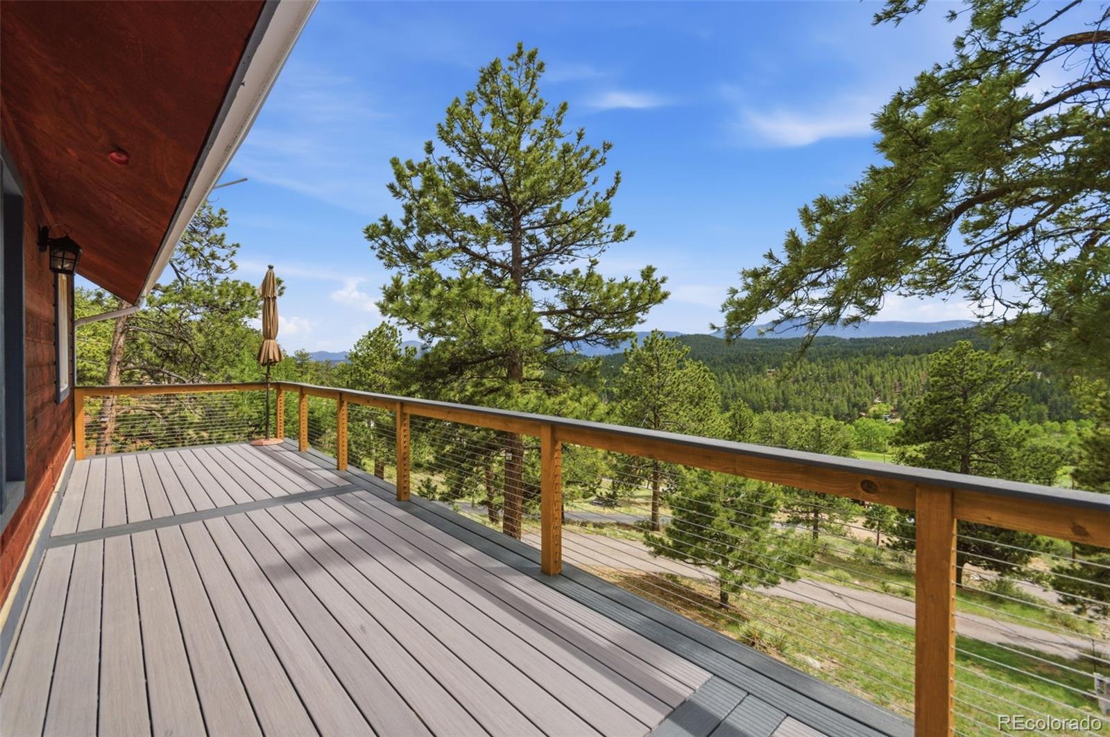 202 Badger Lane Bailey, CO 80421 - Photo 17 of 50 a view of balcony with wooden floor and fence
