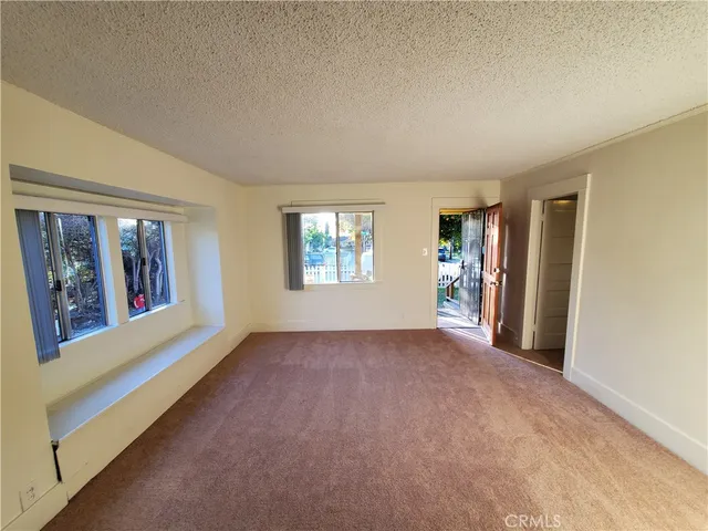 a view of a livingroom with a ceiling fan and window