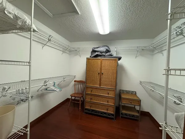 a white toilet sitting next to a bathroom sink and a mirror