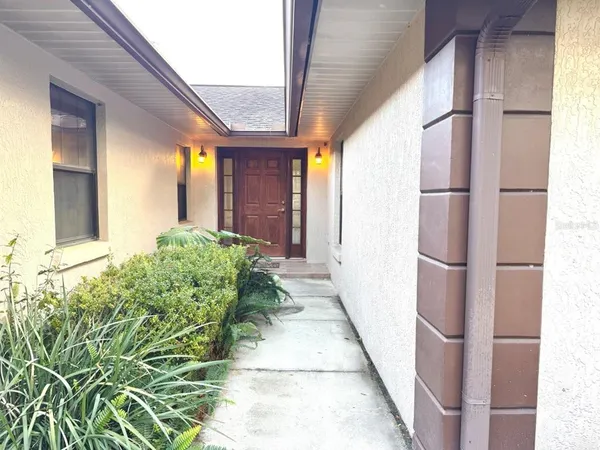 a view of a house with a yard and sitting area
