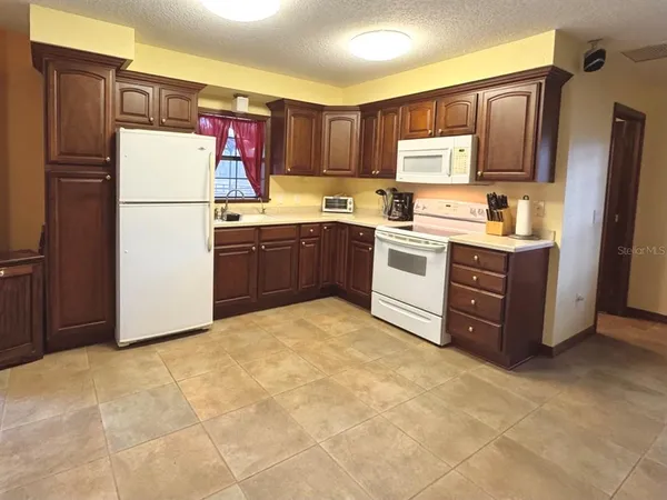 a bedroom with a bed and dresser with mirror