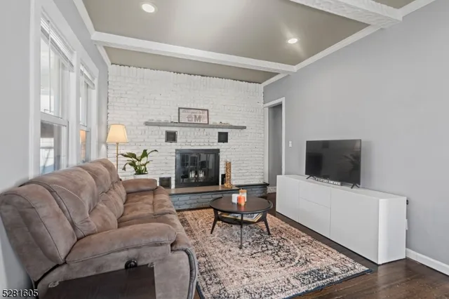 a living room with furniture wooden floor and a fireplace