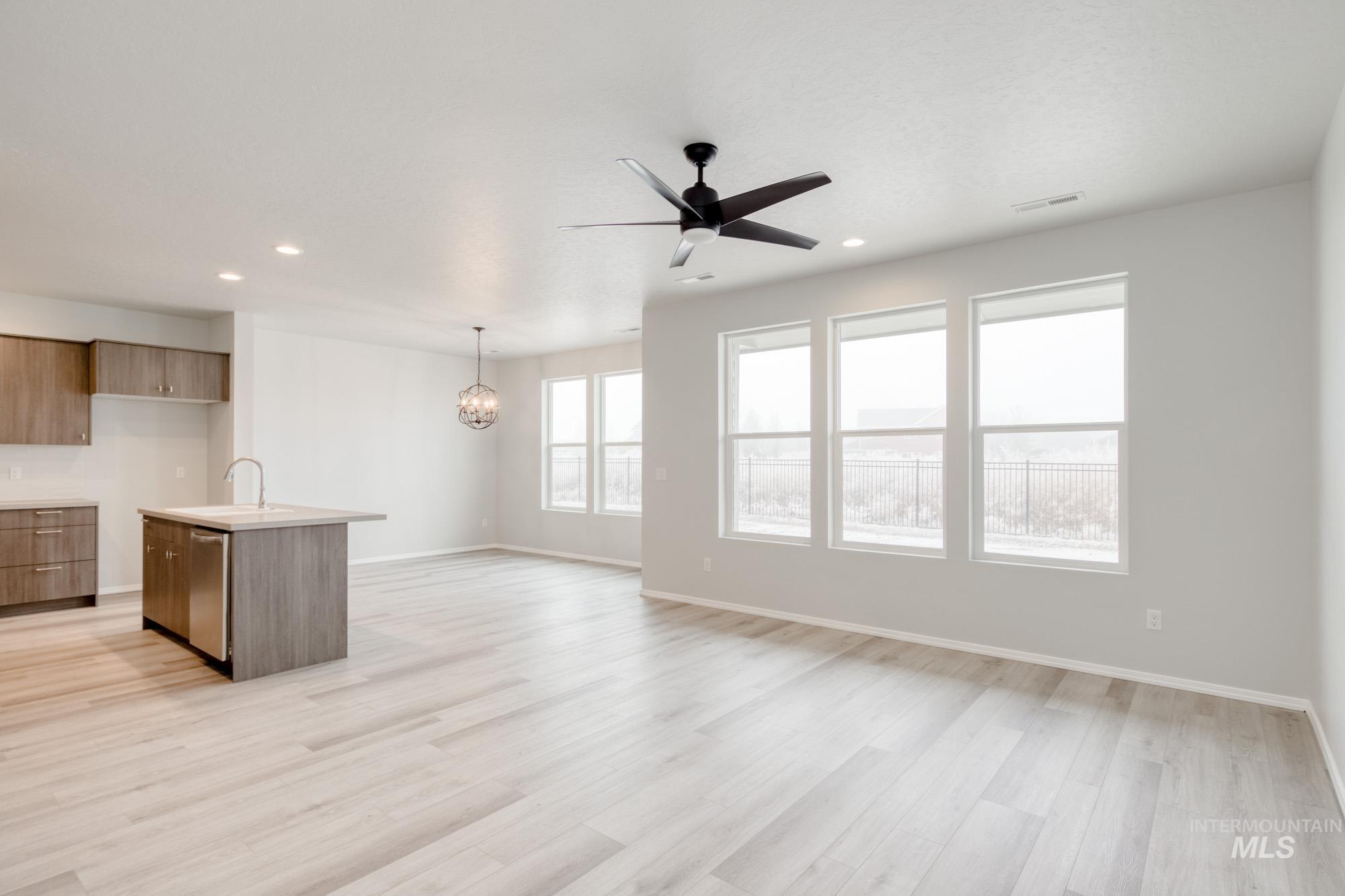 13740 Judson Street Caldwell, ID 83607 - Photo 10 of 23 Kitchen featuring a kitchen island with sink, ceiling fan, recessed lighting, modern cabinets, and light wood-style floors