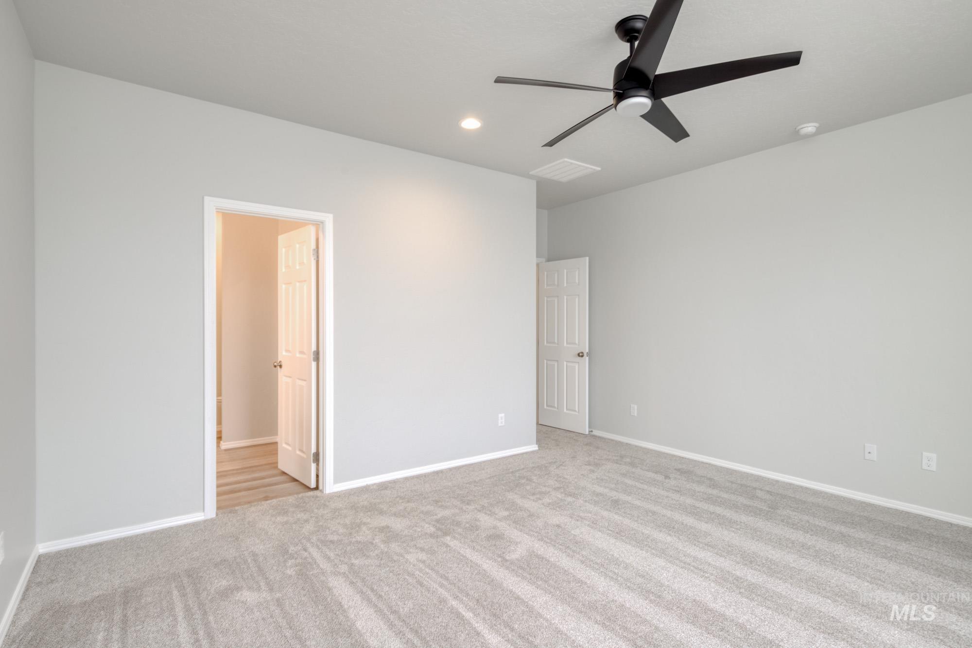 13740 Judson Street Caldwell, ID 83607 - Photo 18 of 23 Unfurnished bedroom with light colored carpet, ceiling fan, and recessed lighting