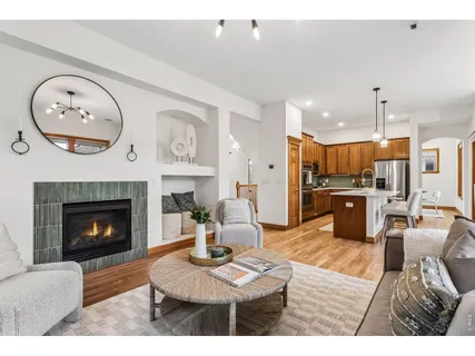 a living room with furniture kitchen view and a fireplace