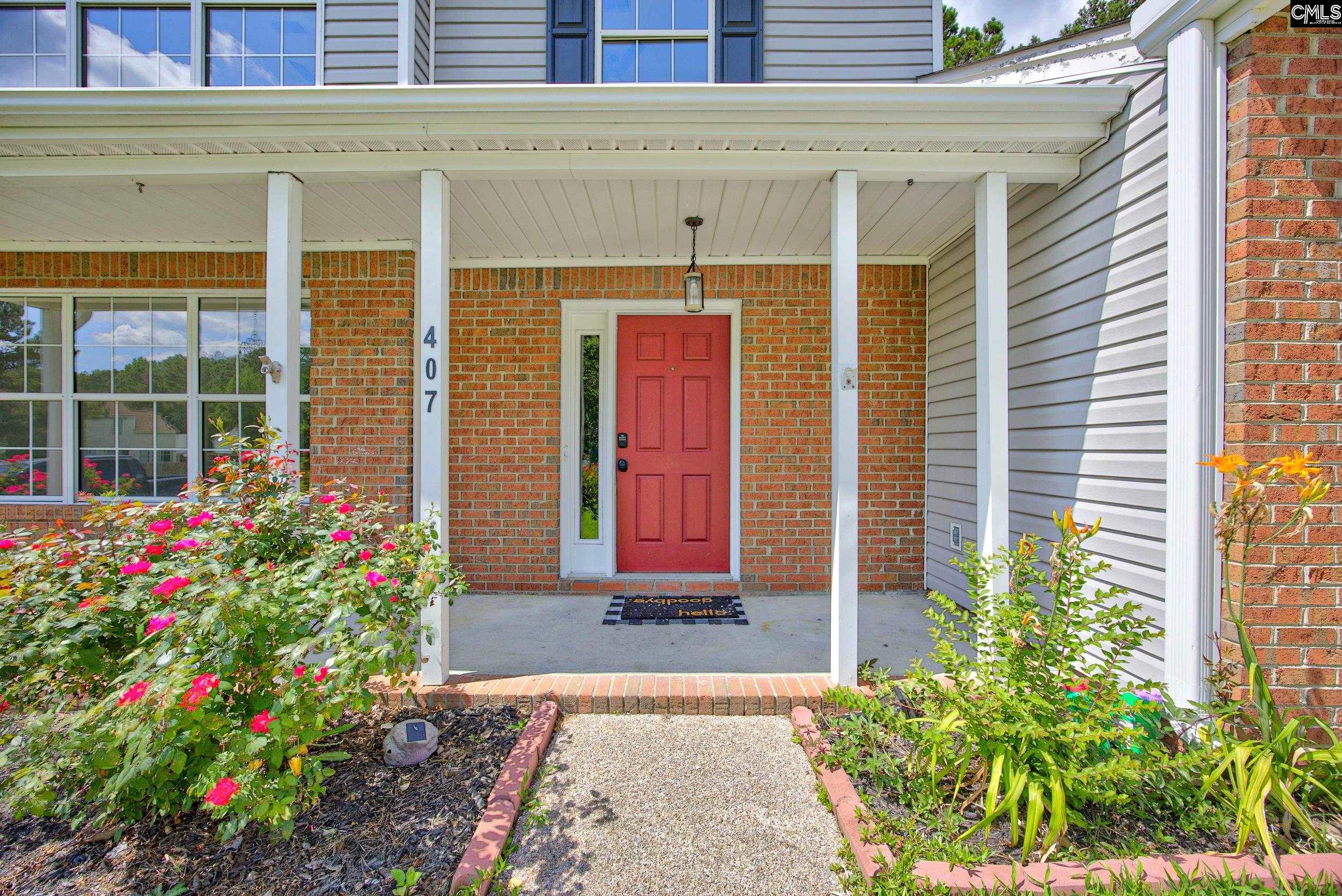 407 Sesqui Trail Columbia, SC 29223 - Photo 6 of 34 a flower garden in front of a building