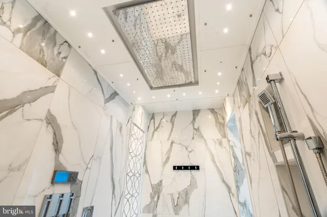 a view of a hallway with wooden floor and a living room