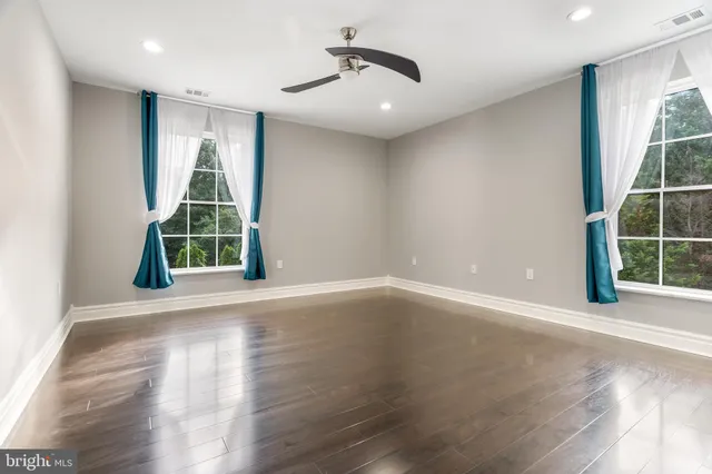 a spacious bathroom with a granite countertop sink toilet and shower