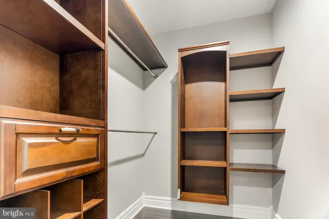 a view of a kitchen with furniture a ceiling fan and wooden floor