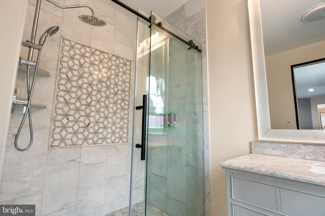 a bathroom with a granite countertop sink a toilet and a bathtub