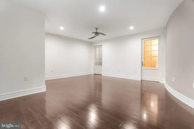 a white house that has a tree in front of it