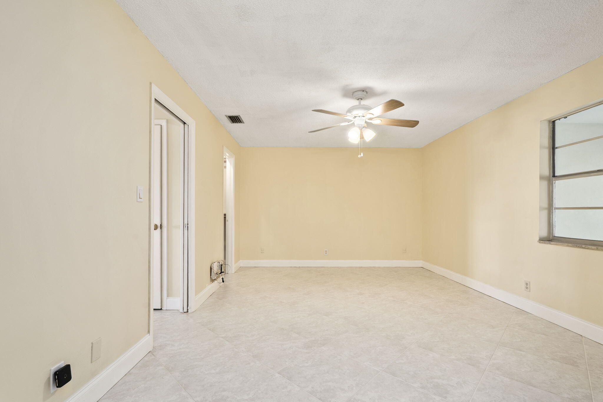 311 Colony Lane, Unit C Fort Pierce, FL 34982 - Photo 12 of 24 a view of an empty room with a window