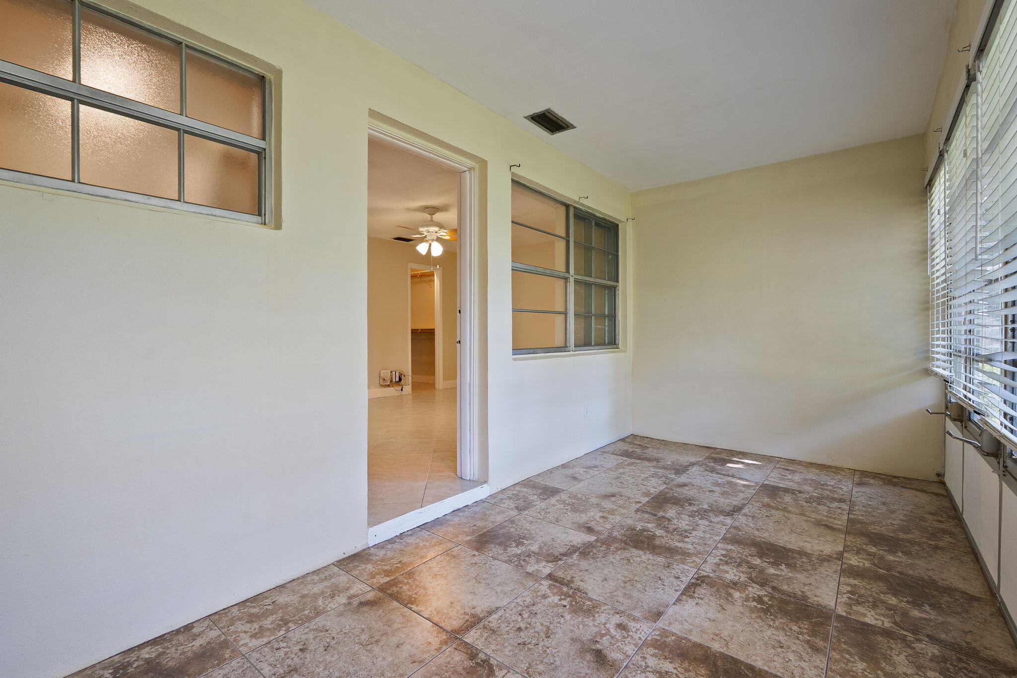 311 Colony Lane, Unit C Fort Pierce, FL 34982 - Photo 16 of 24 an empty room with windows