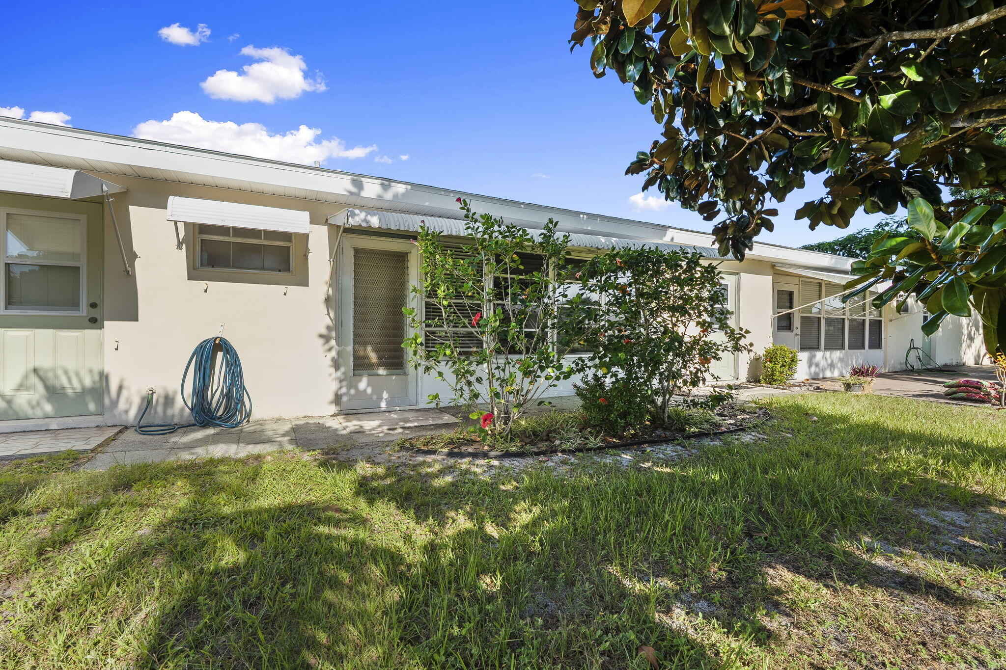 311 Colony Lane, Unit C Fort Pierce, FL 34982 - Photo 23 of 24 a front view of a house with garden