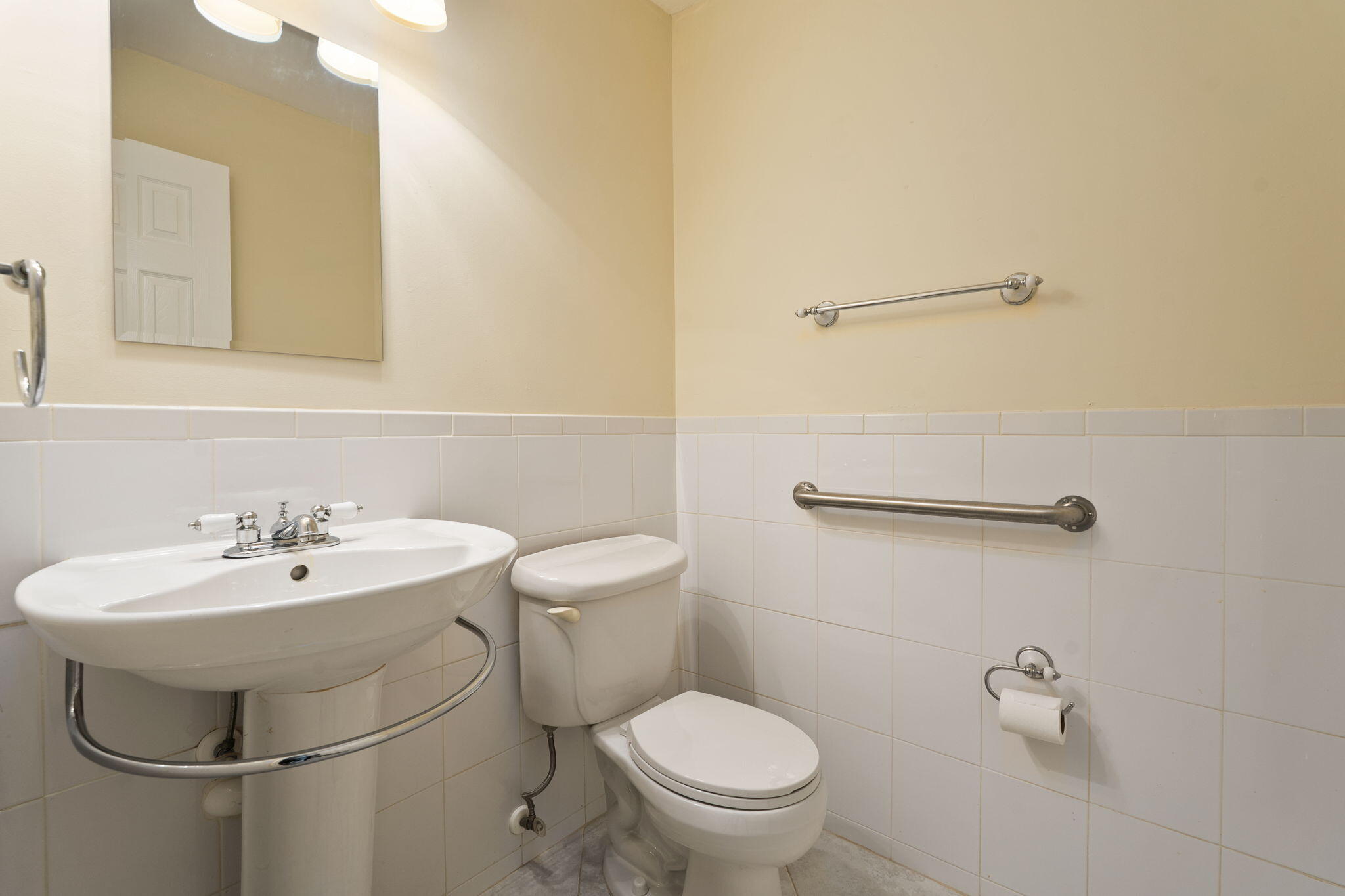 311 Colony Lane, Unit C Fort Pierce, FL 34982 - Photo 8 of 24 a bathroom with a sink toilet and a mirror