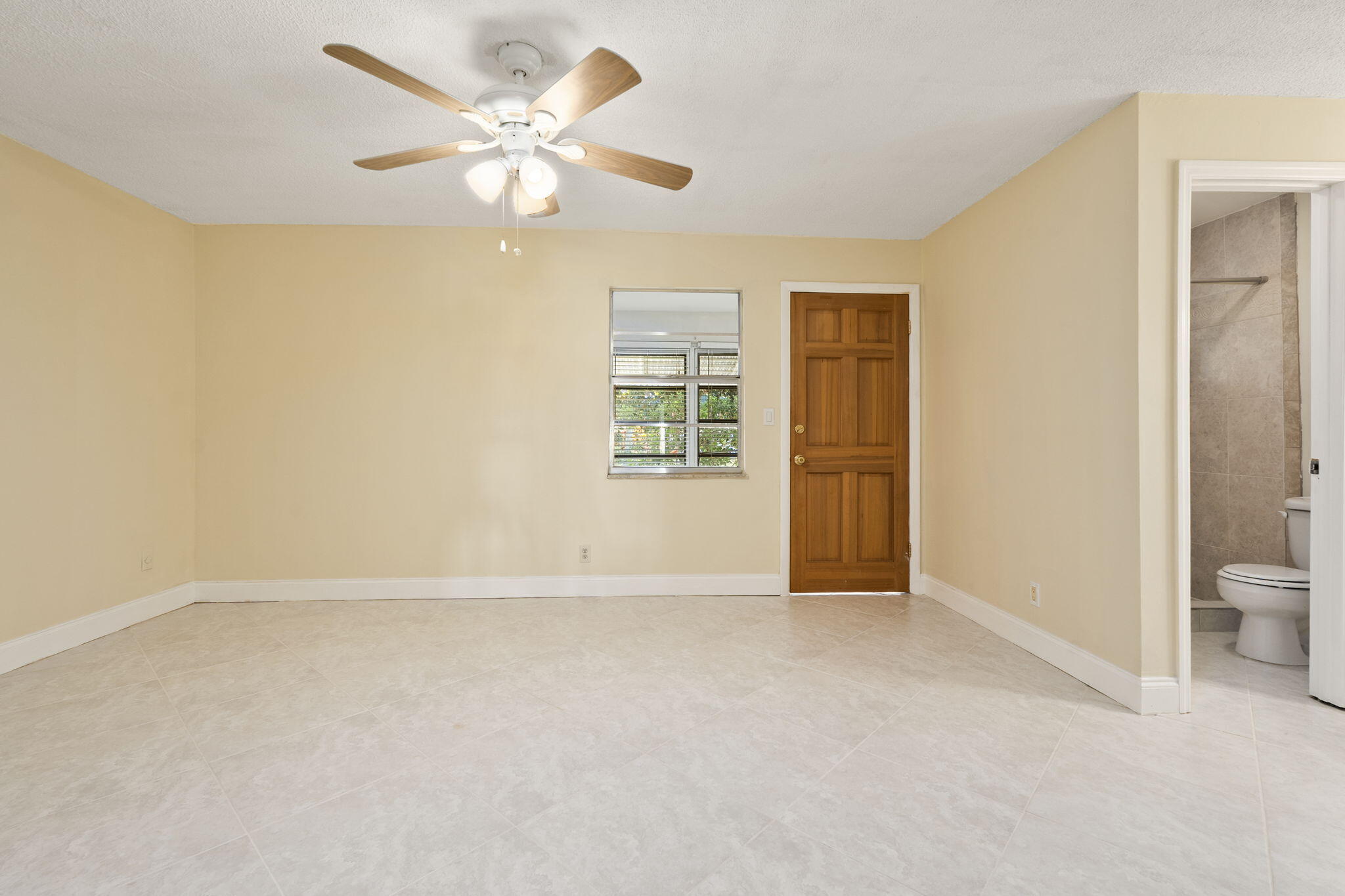 311 Colony Lane, Unit C Fort Pierce, FL 34982 - Photo 9 of 24 a view of an empty room with a window