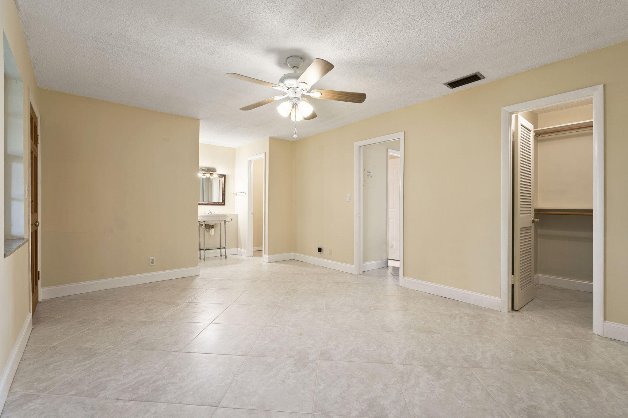 311 Colony Lane, Unit C Fort Pierce, FL 34982 - Photo 10 of 24 an empty room with closet and a ceiling fan