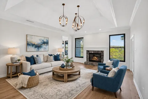 a living room with furniture a fireplace and a table