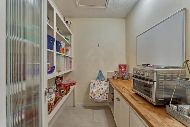 a bathroom with a tub shower sink and mirror