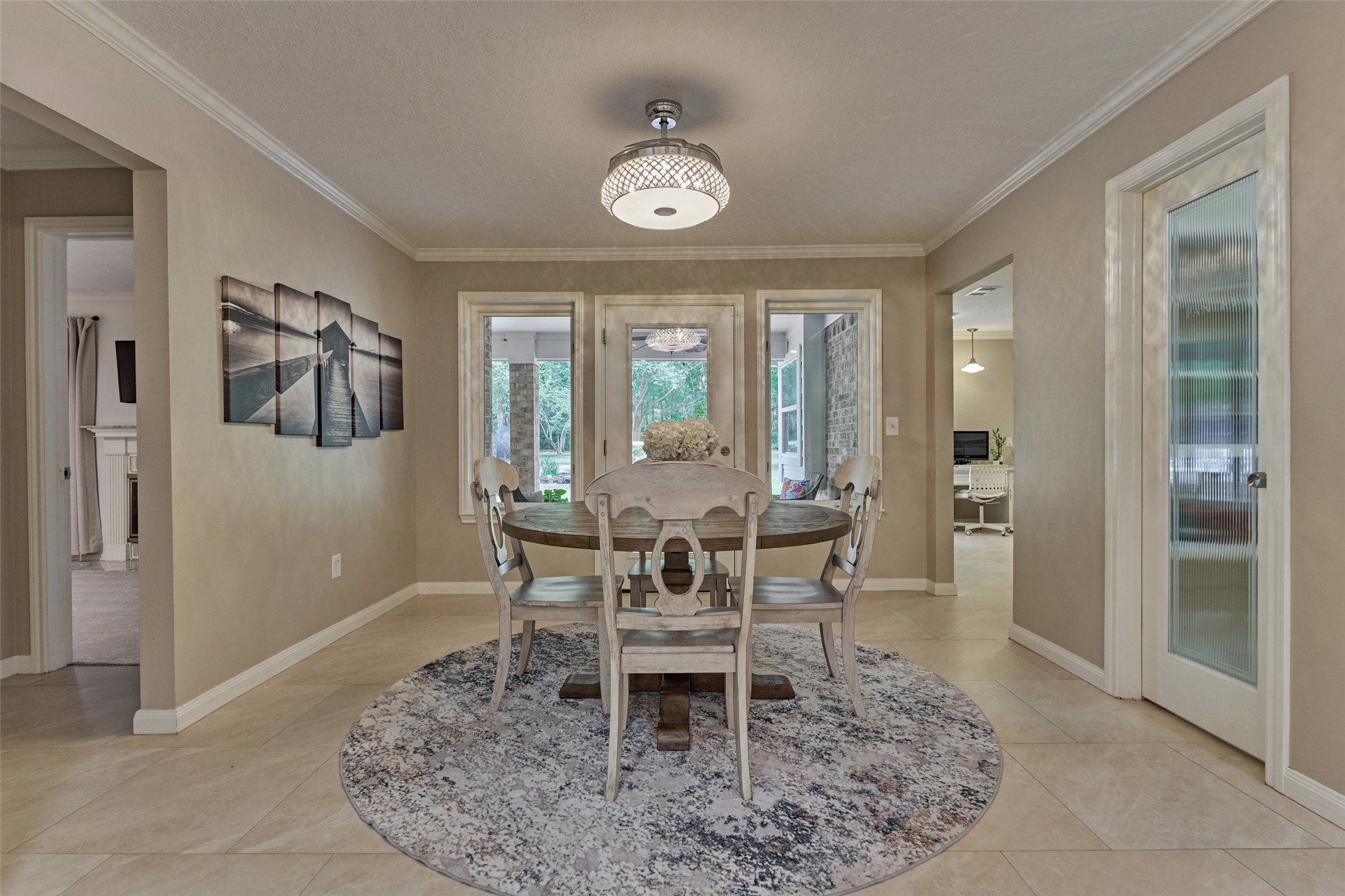 8 Wind River Court Conroe, TX 77384 - Photo 11 of 50 Sunny breakfast room with sweeping views of the private backyard. Note the well-appointed, walk-in pantry access with frosted glass door.