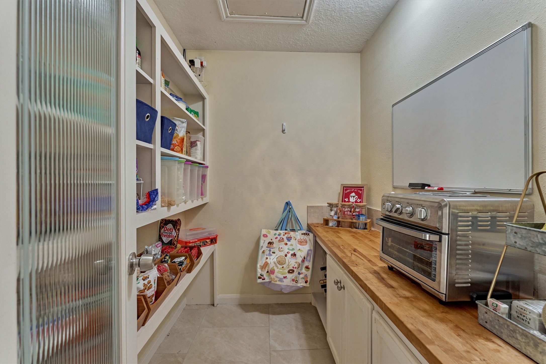 8 Wind River Court Conroe, TX 77384 - Photo 12 of 50 Exceptional storage in this walk-in pantry with prep counter. Note the pull down attic access to planked storage above.