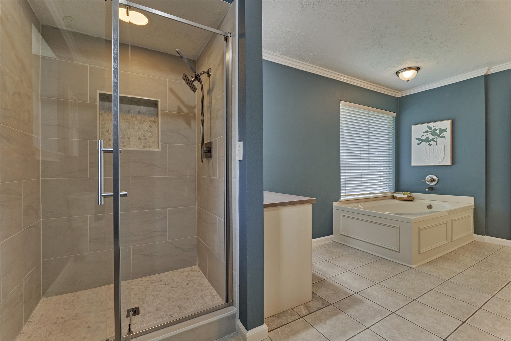 8 Wind River Court Conroe, TX 77384 - Photo 16 of 50 Seamless stall shower with modern tile detail and handheld shower wand.