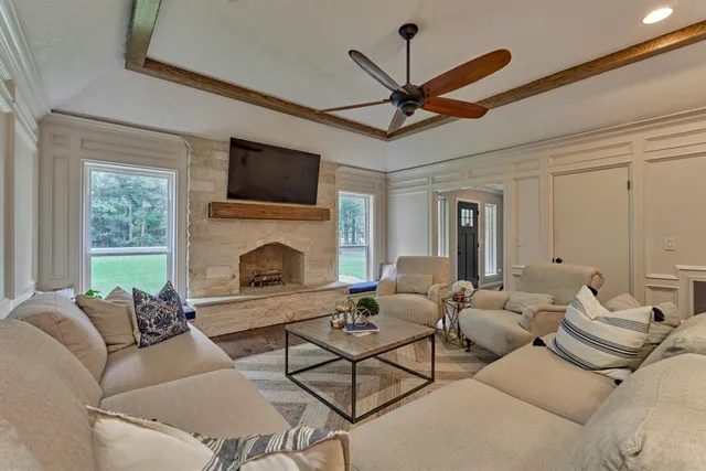 a view of a dining room with furniture a chandelier and wooden floor