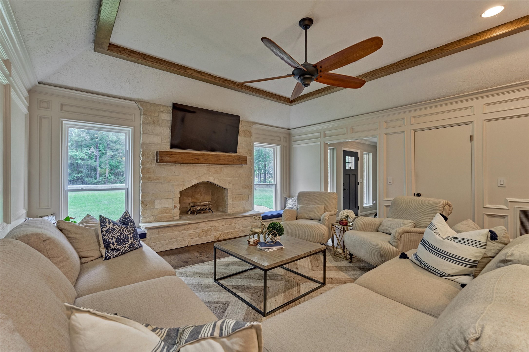 8 Wind River Court Conroe, TX 77384 - Photo 19 of 50 Stunning remodel features limestone woodburning fireplace with reclaimed wood mantel and hardwood flooring. Don't miss the spacious closet for storage - perfect for holiday decor!