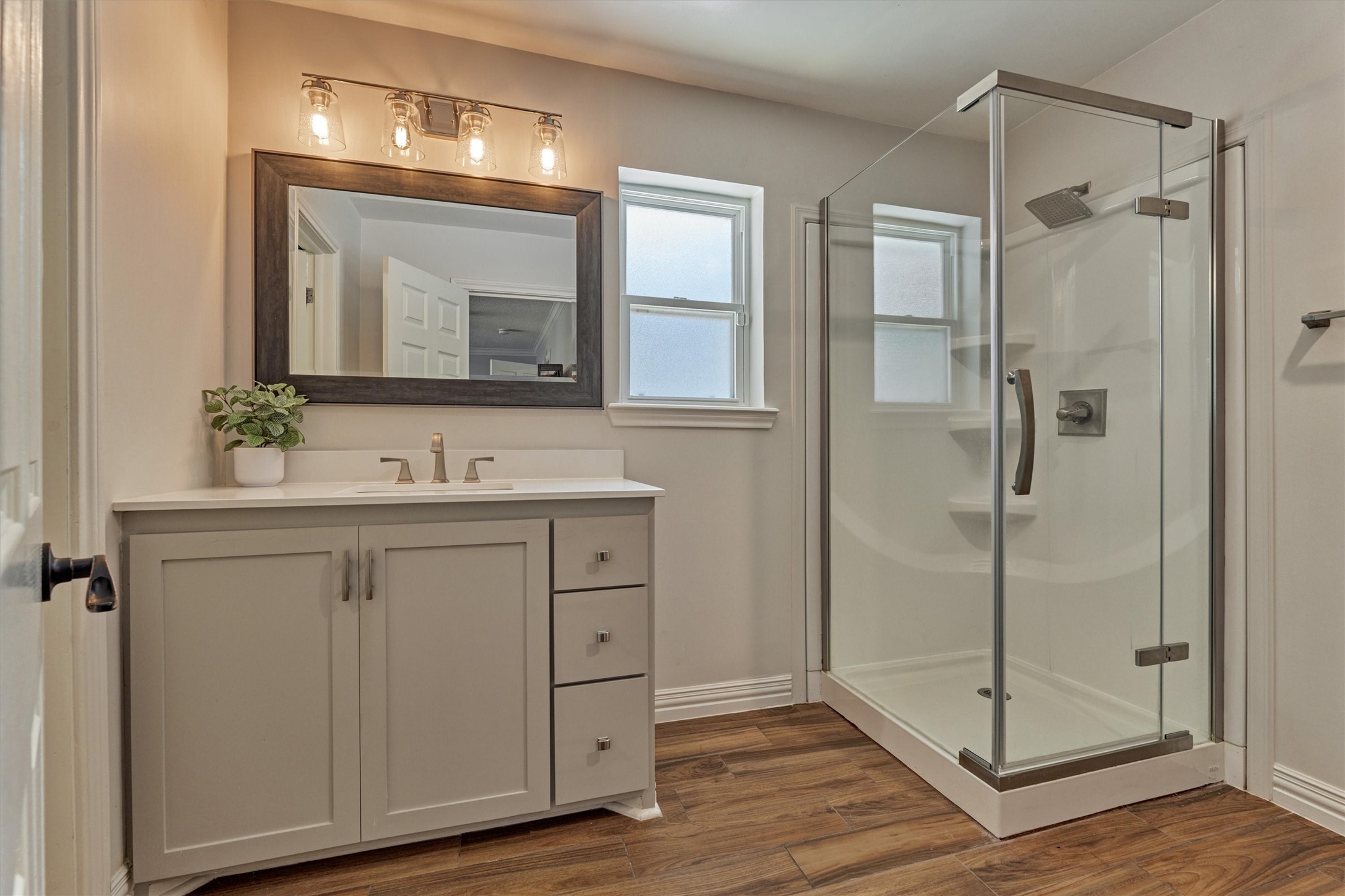 8 Wind River Court Conroe, TX 77384 - Photo 26 of 50 Bedroom 3 offers an updated bath with ample storage and sleek walk in shower.