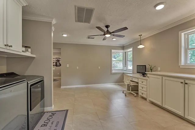 a view of house with garden space and sitting area