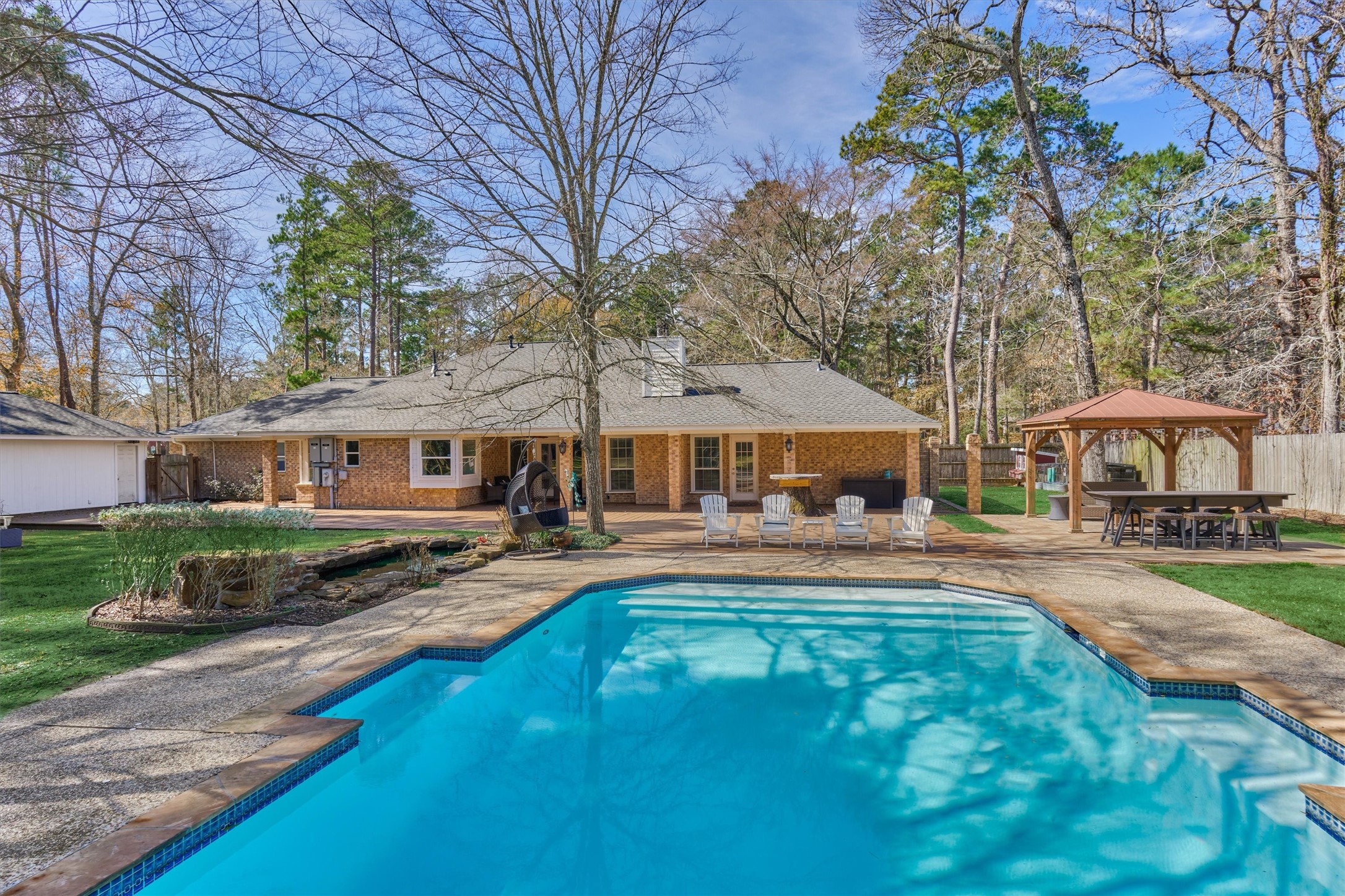 8 Wind River Court Conroe, TX 77384 - Photo 3 of 50 Relax poolside on these warm summer days! Pool can be heated for year round enjoyment!