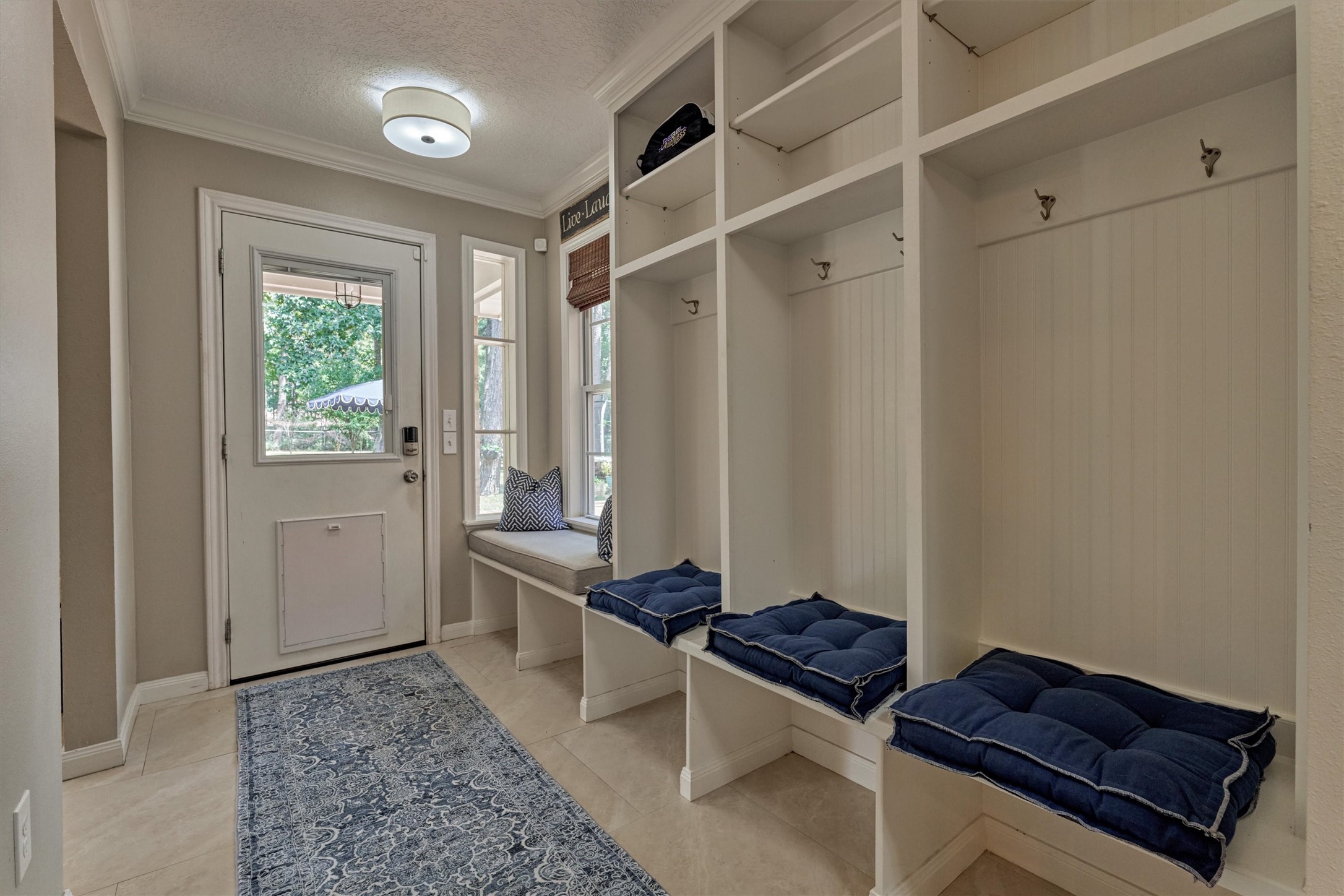 8 Wind River Court Conroe, TX 77384 - Photo 31 of 50 Wow! Custom mudroom storage maximizes the use of this space as you come in from the garage. Don't miss the adjacent utility closet.